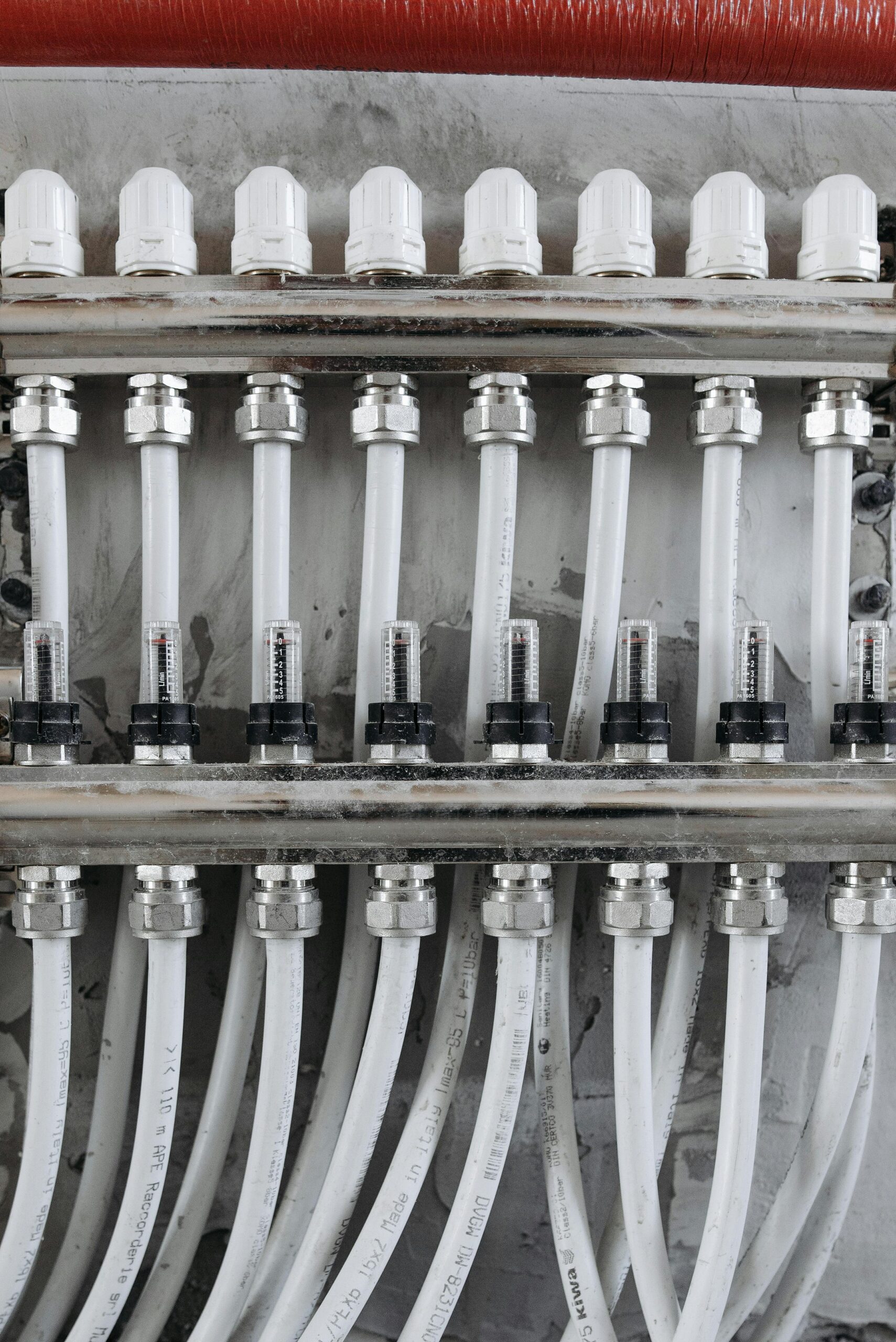 Close-up view of an industrial pipe connection system with gauges and valves.